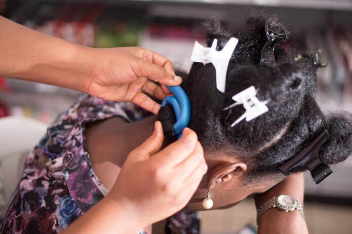 Hands of a Person Curling a Woman's Hair