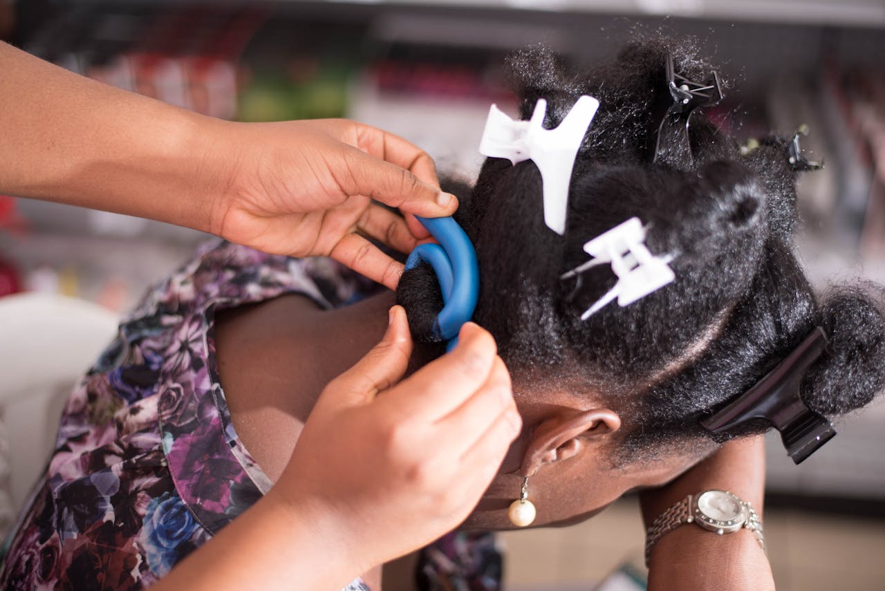 Hands of a Person Curling a Woman's Hair